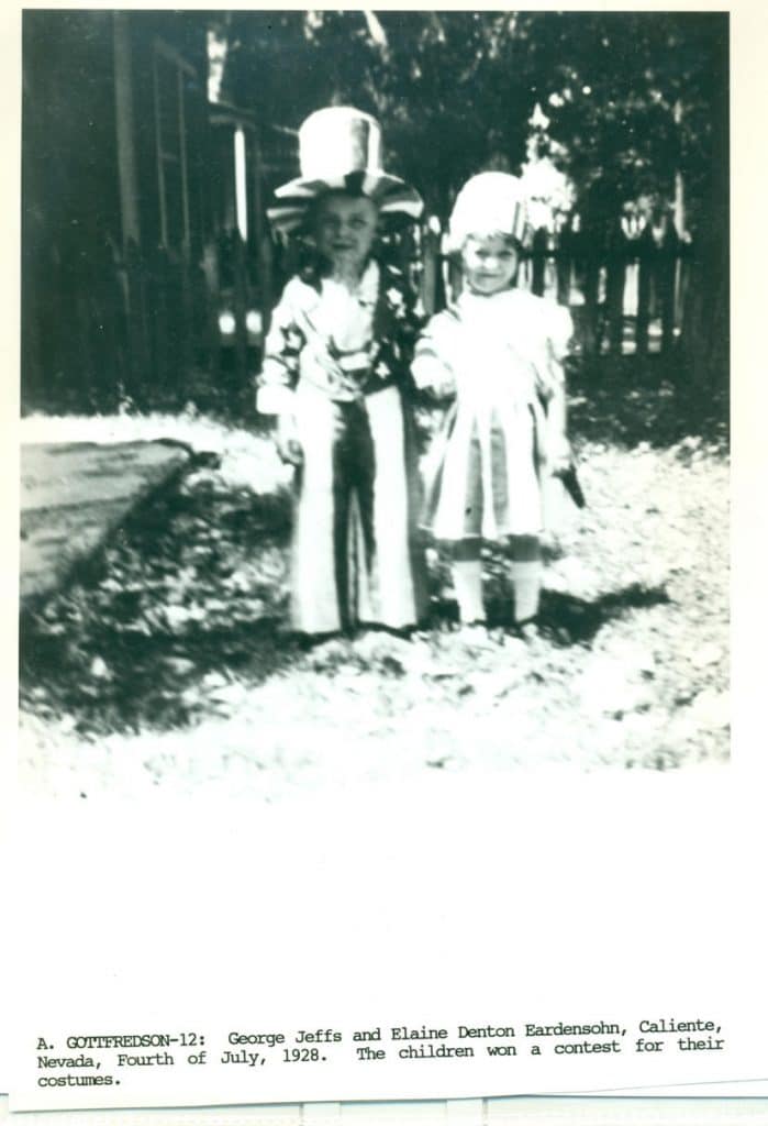 Two children, one in an Uncle Sam costume and one in a white dress, stand outdoors.