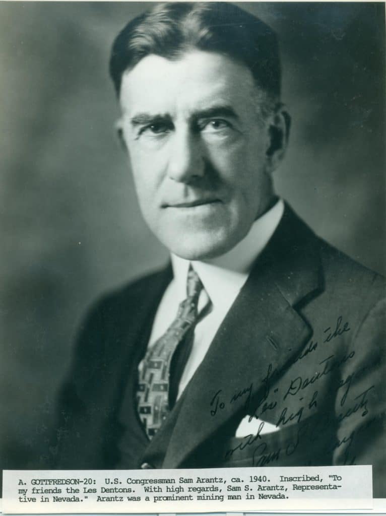 A black and white portrait of a man in a suit and patterned tie, with text "To my friends the Les Dentons."