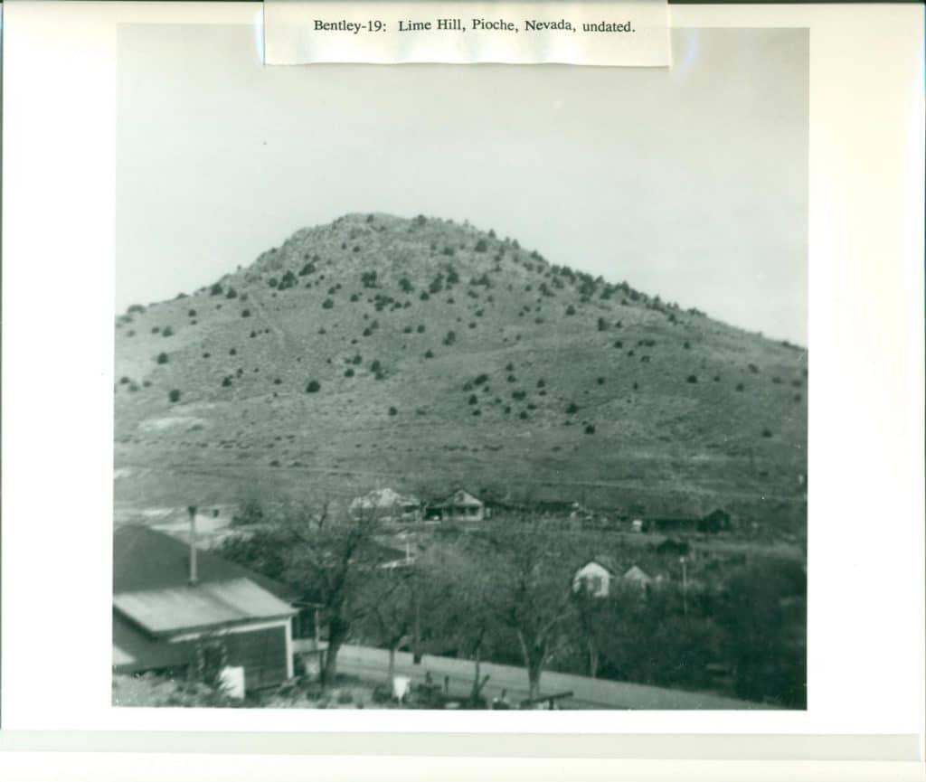 A black and white photo shows a large, sparse hill above a small town; "Bentley-19: Lime Hill, Pioche, Nevada, undated."