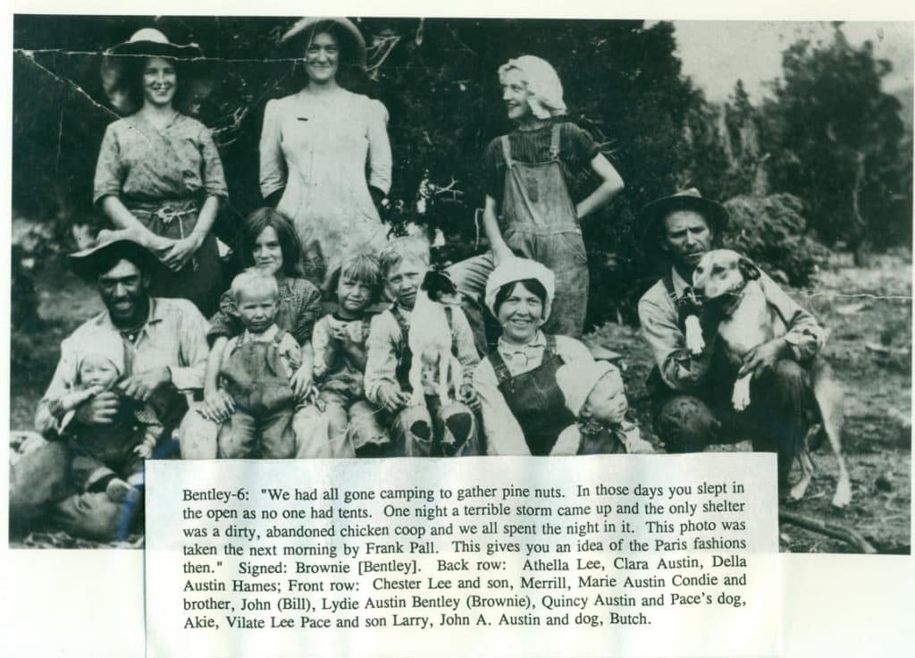 A sepia-toned outdoor photo of a large family with children and dogs, with text at the bottom.