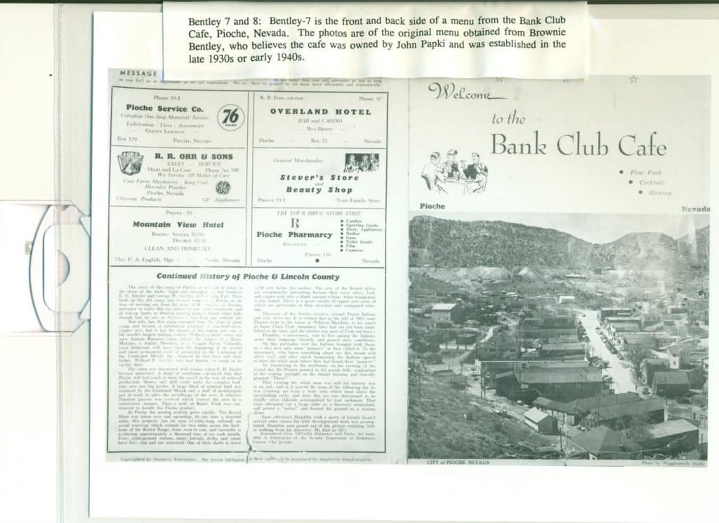 A vintage menu from "Bank Club Cafe" with a black and white photo of a town nestled in mountains.