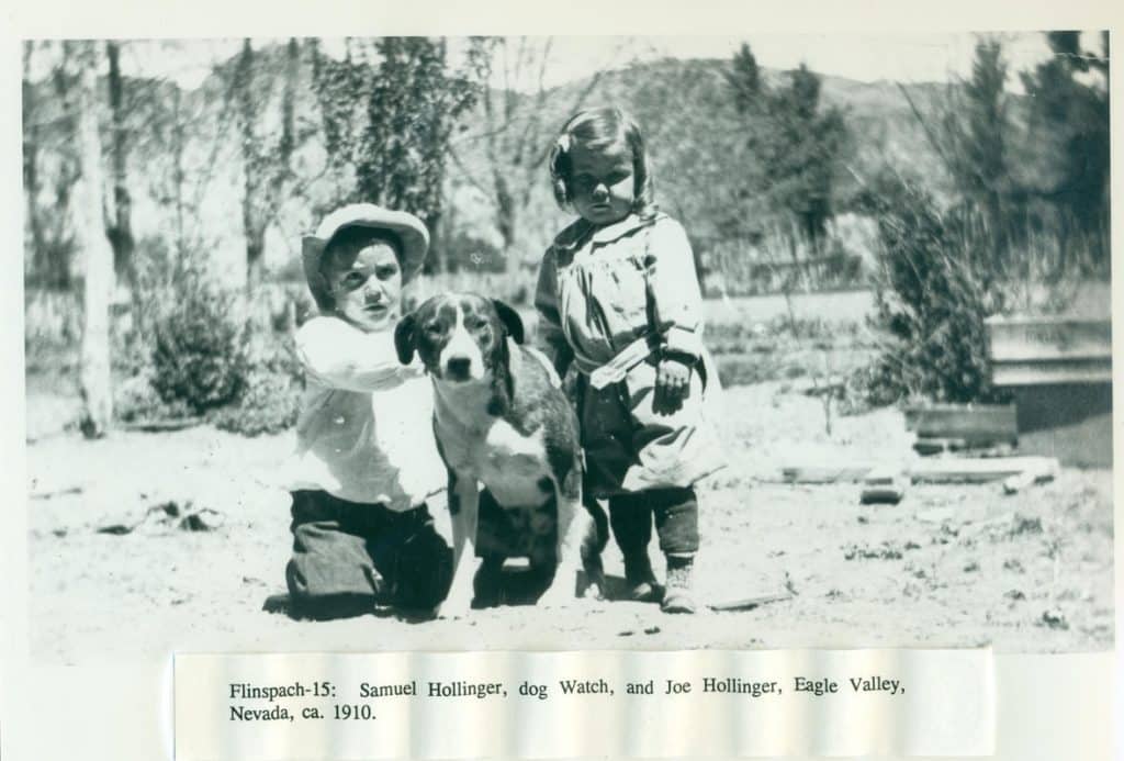 Two children and a dog pose outdoors, with "Flingspach-15: Samuel Hollinger, dog Watch, and Joe Hollinger, Eagle Valley, Nevada, ca. 1910." at the bottom.