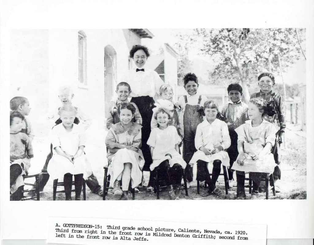 A black and white photo of a 1920s third-grade class with a teacher and 11 students.