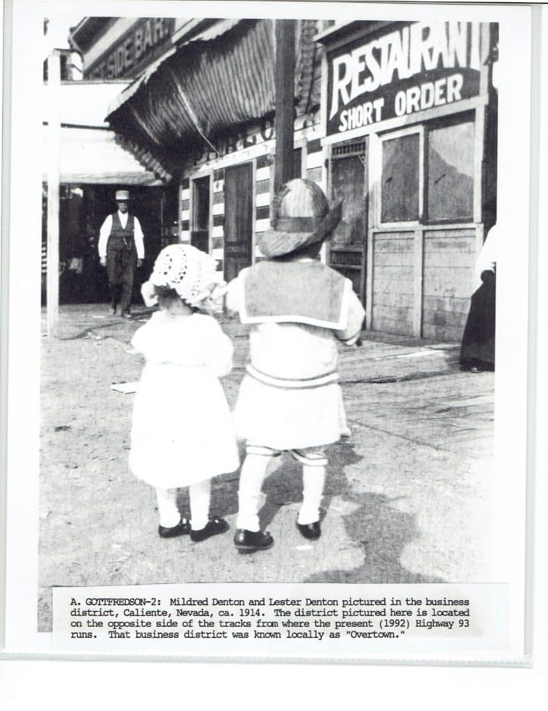 Two children, seen from behind, stand before a "RESTAURANT SHORT ORDER" in a 1914 photo.