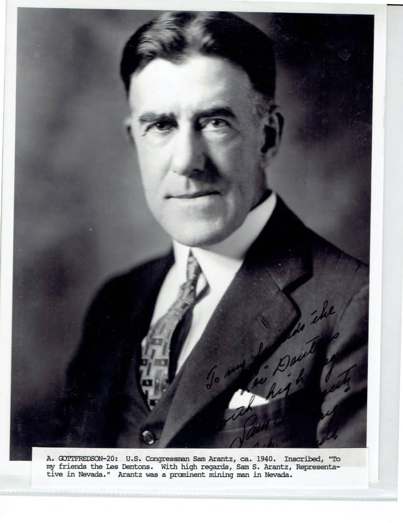 A black and white portrait shows a man in a suit and tie with "To my friends the Les Dentons" inscribed.