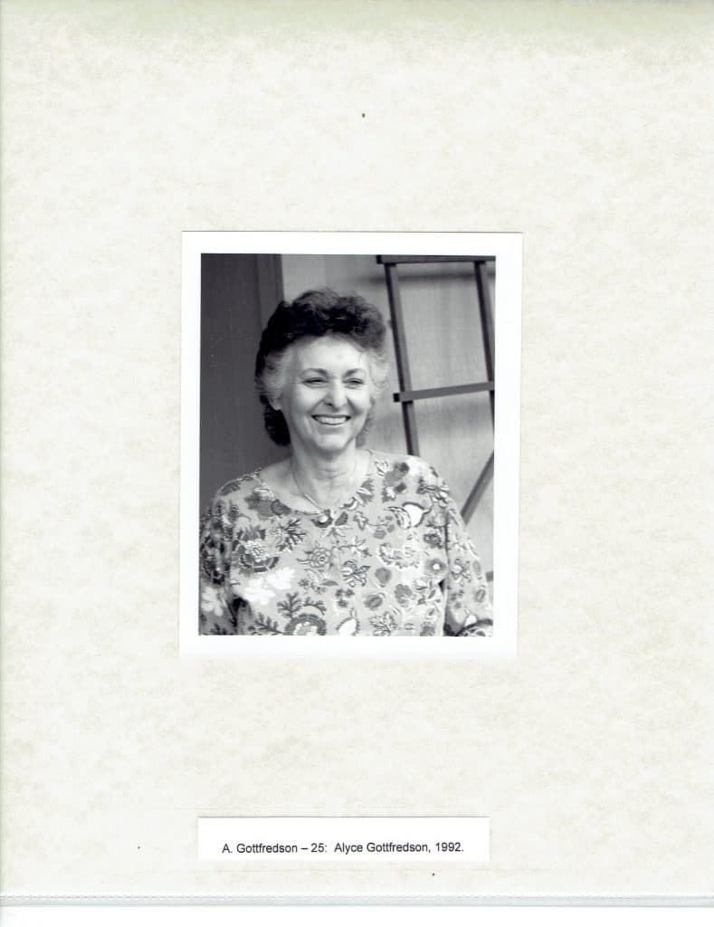 A smiling woman with curly hair and a patterned shirt, "A. Gottfredson - 25: Alyce Gottfredson, 1992."