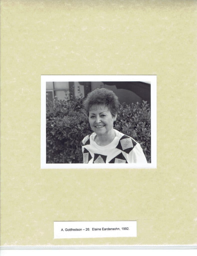 A smiling woman with short, dark hair and a patterned shirt stands in front of bushes. "A. Gottfredson - 26: Elaine Eardensohn, 1992."
