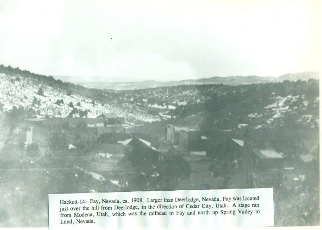 A faded black and white photo shows a town nestled in a valley with hills and mountains in the distance, and text "Hackett-14: Fay, Nevada, ca. 1908."