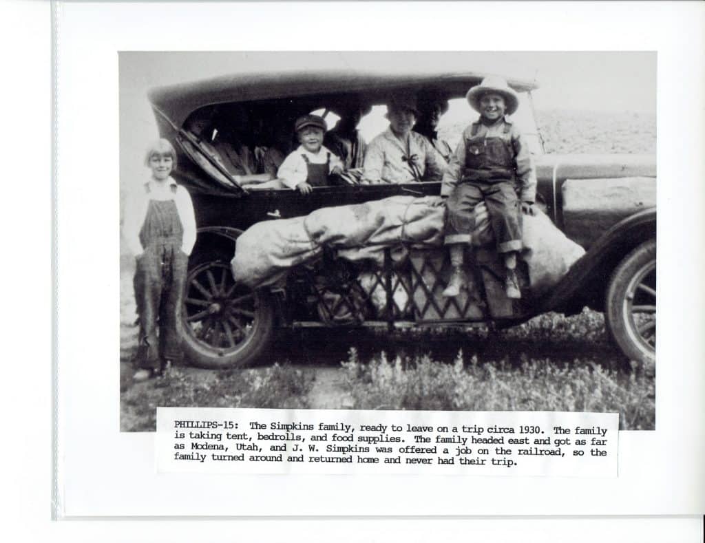 A 1930 black and white photo shows a family of five with a car packed for a trip.
