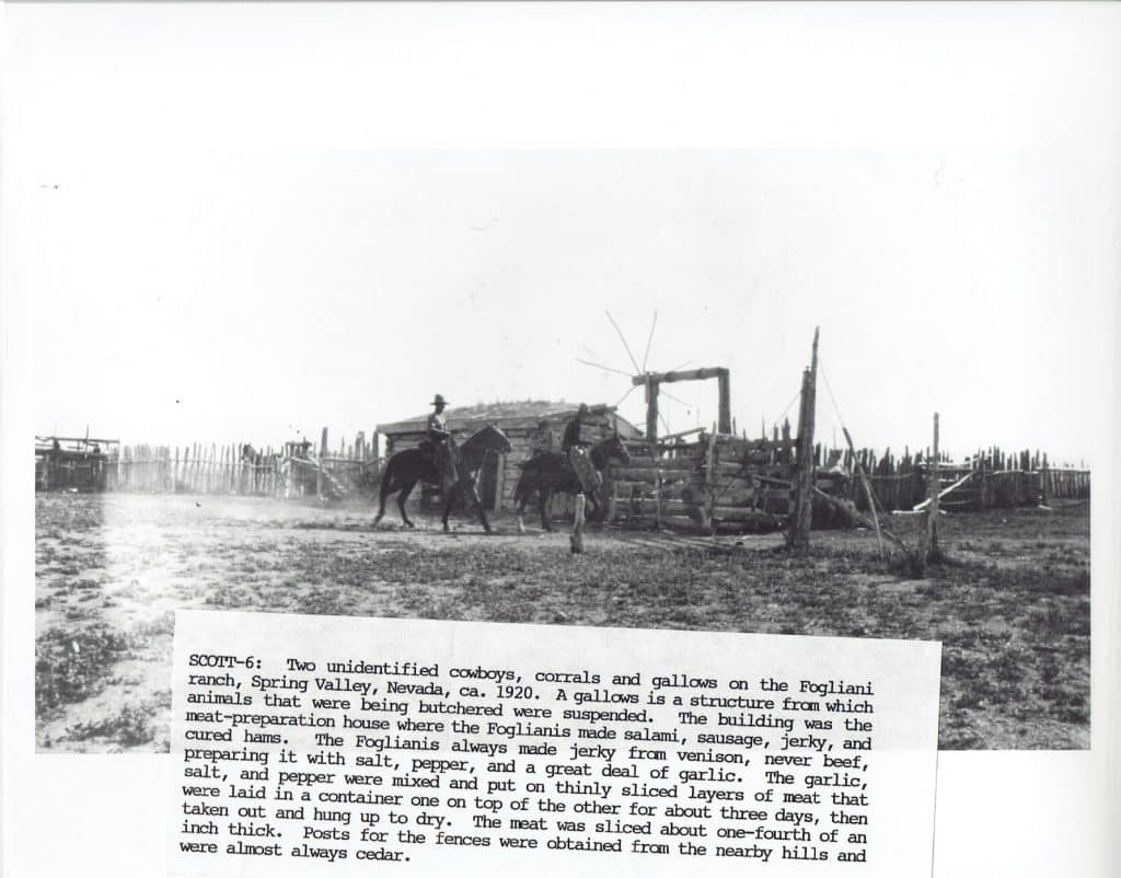 Two cowboys on horseback near a wooden building and corrals on a dry, dusty ranch.