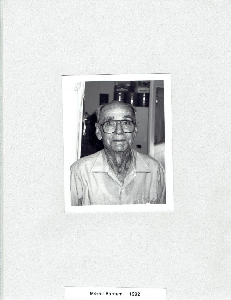 A black and white photo shows an older man with glasses looking directly at the camera, with "Merrill Barnum - 1992" below.