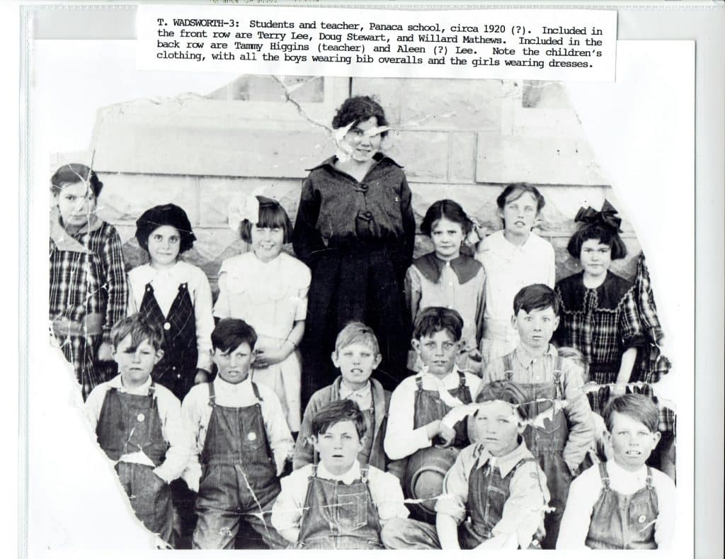 A group of 16 students and one teacher pose for a class photo, with text "T. WADSWORTH-3: Students and teacher, Panaca school, circa 1920 (?).".